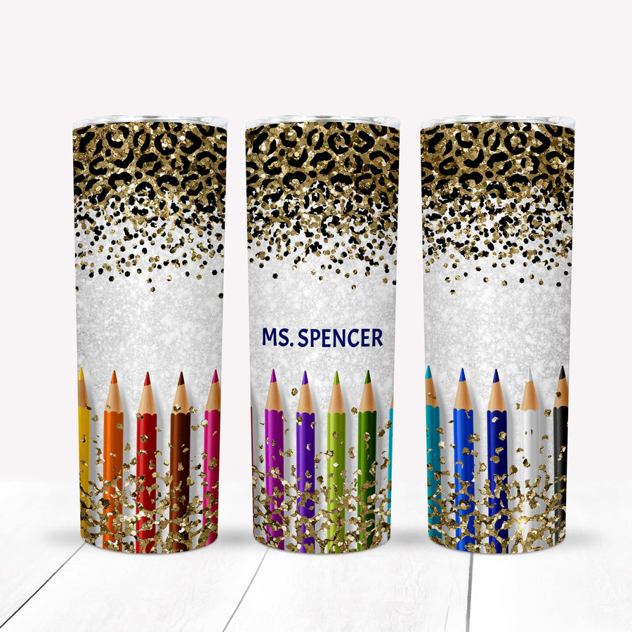Personalized stainless steel tumbler with glitter, pencils, and the name "Ms. Spencer" in a stylish design.