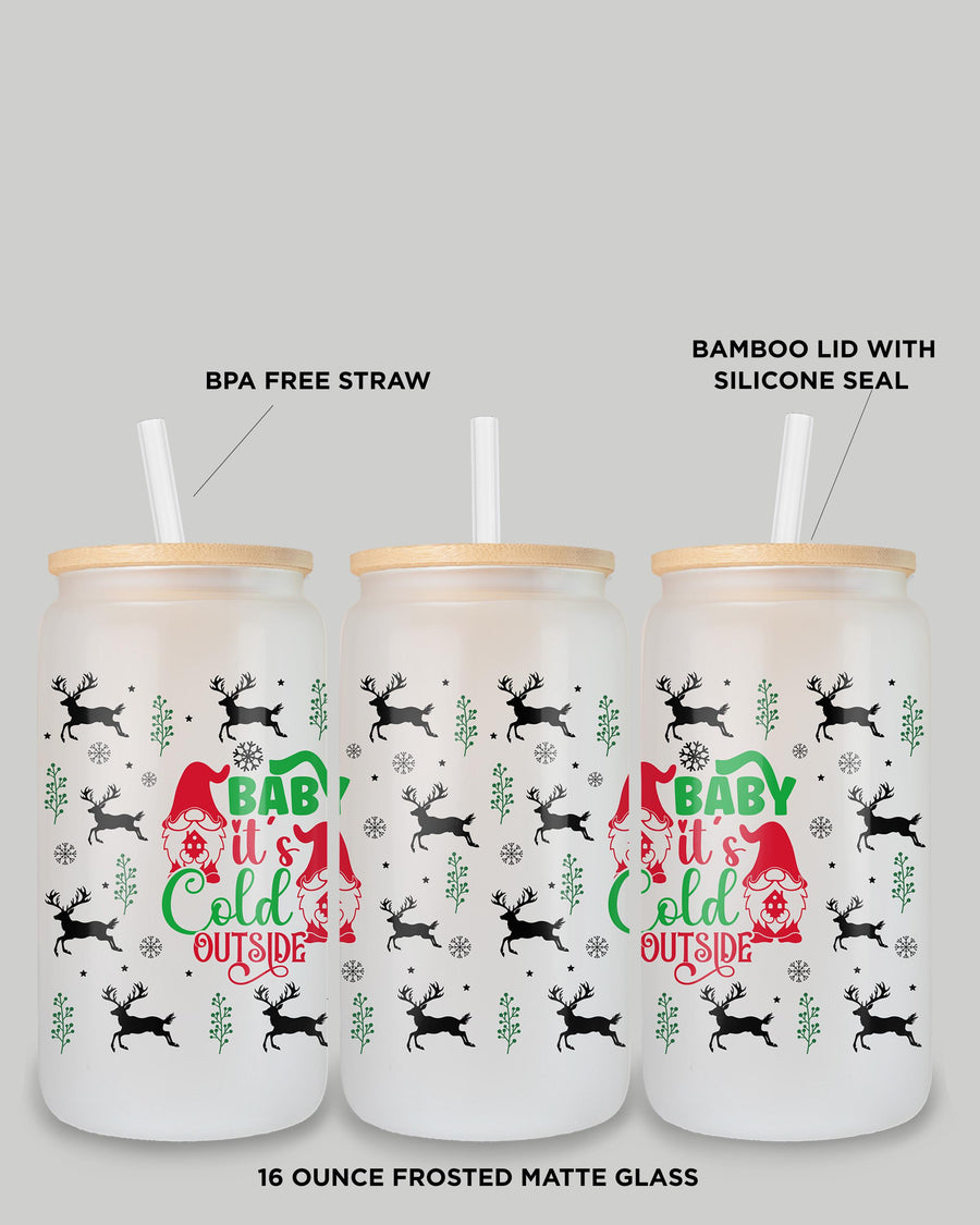 Lifestyle image of 'Baby It’s Cold Outside' frosted glass tumbler with holiday decor.