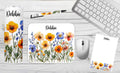 Personalized wildflower desk set featuring a tumbler, mousepad, notepad, and pen with floral designs and the name "Debbie.