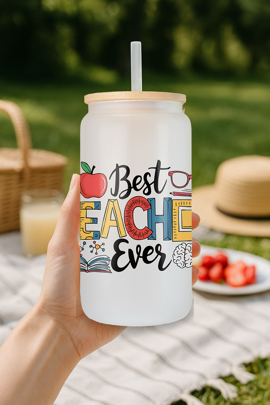 Lifestyle image of 'Best Teacher Ever' frosted glass can tumbler on desk.