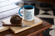 “Sometimes you forget you're awesome” mug with blue handle, placed on a wooden cutting board with a slice of bread.