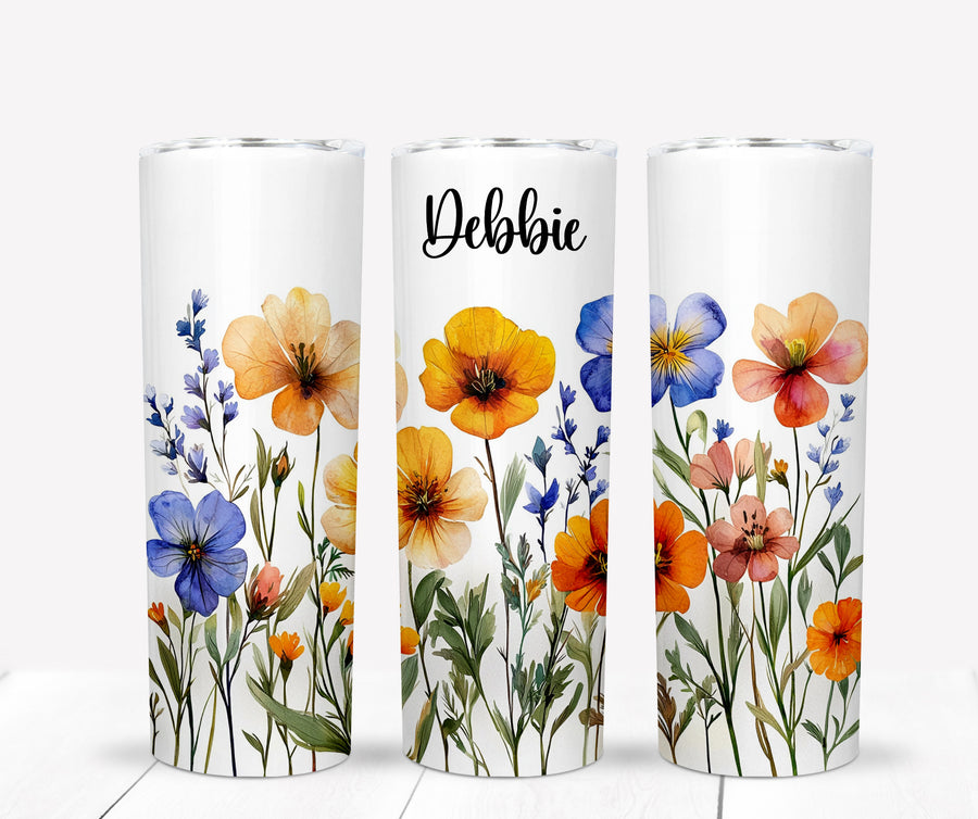 Personalized wildflower desk set featuring a tumbler, mousepad, notepad, and pen with colorful floral designs.