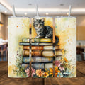 Cute cat sitting on stacked books with floral accents on a stainless steel 20oz tumbler.
