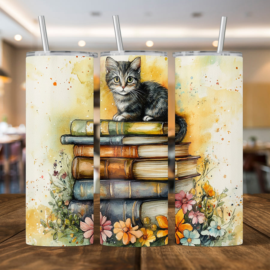 Cute cat sitting on stacked books with floral accents on a stainless steel 20oz tumbler.