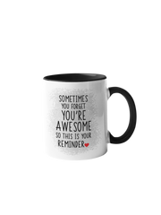 “Sometimes you forget you're awesome” coffee mug with a black handle and rim, featuring bold text on a white background.