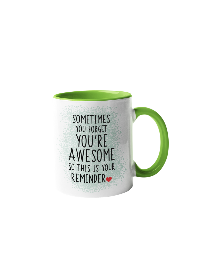 “Sometimes you forget you're awesome” coffee mug with a white body and green handle, featuring black text design.