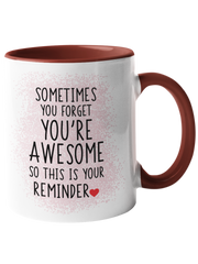 Burgundy coffee mug with black text stating "Sometimes you forget you're awesome so this is your reminder.