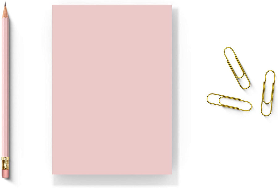 5” x 7” pink blank notepad with 50 sheets, surrounded by a pencil and gold paper clips on a white background.